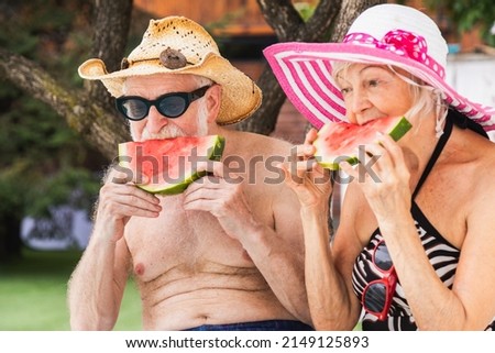 Happy senior couple having party in the swimming pool - Elderly friends releaxing at a pool party during summer vacation Royalty-Free Stock Photo #2149125893