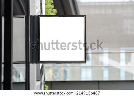 Background advertisement sign mockup blank space, light box sign hanging from retail store front in city town center street shopping market, modern white empty for adding business logo advert