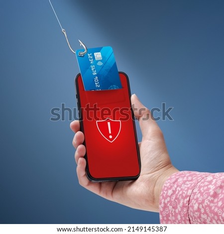 Phishing and cyber security: hacker stealing a user's credit card information on a smartphone Royalty-Free Stock Photo #2149145387