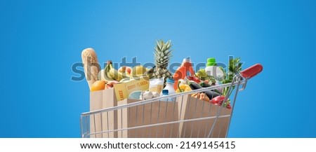 Shopping cart full of fresh groceries, grocery shopping concept Royalty-Free Stock Photo #2149145415