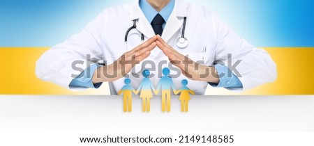 Humanitarian aid and medical care for war in Ukraine. Doctor hands protect symbol of family icon in yellow and blue colors of Ukraine flag. Relief for the injured and refugees. Banner with copy space