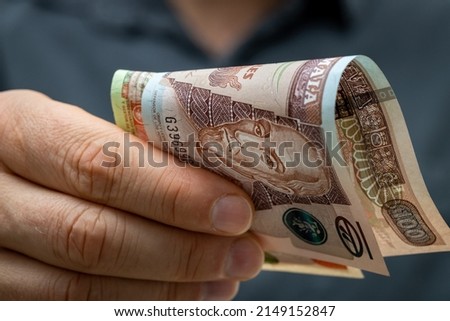 Guatemala money, File of banknotes called qutzales held in front of each other in hands, financial business concept, close up