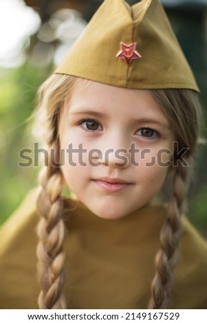 large portrait of a blonde girl in the uniform of the Soviet army on May 9