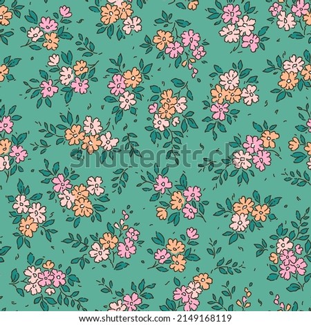 Beautiful floral pattern in small abstract flowers. Small colorful flowers. Blue green background. Ditsy print. Floral seamless background. The elegant the template for fashion prints. Stock pattern.