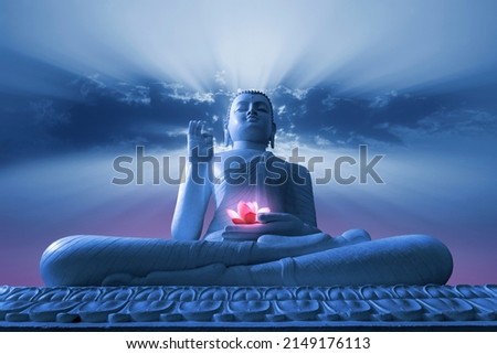 Buddha statue with cloud and sun rays background