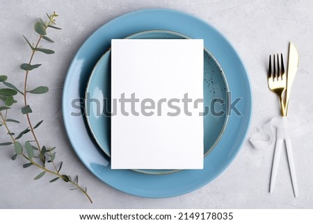 Wedding stationery invitation card mockup 5x7 on grey background with eucalyptus, Menu card mockup with festive wedding or birthday table setting, blue ceramic plate. Minimal blank card mockup