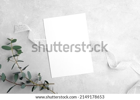 Wedding stationery invitation card mockup 5x7 on neutral grey stone background with eucalyptus leaves, natural lighting, bridal shower mockup Minimal blank card mockup, thank you card, greeting card