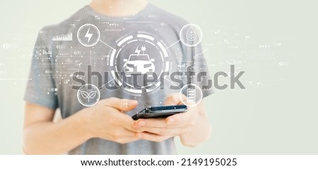 EV concept with young man using a smartphone