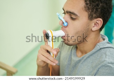 Patient checking his lung function with spirometer Royalty-Free Stock Photo #2149199929