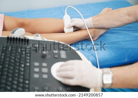 Medical specialist performing doppler ultrasound of the lower limb vessels Royalty-Free Stock Photo #2149200857
