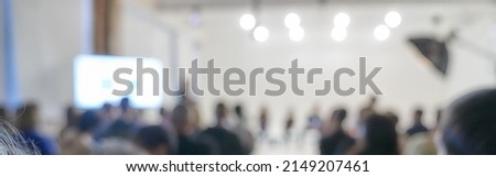 Blurred background of the business conference, a group of people on the stage, presentation of the project, public talk. High quality banner with copy space