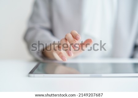 Hands of a woman operating a tablet PC Royalty-Free Stock Photo #2149207687