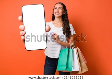 Excited woman loving online shopping on her smartphone and saving money with a mobile app 