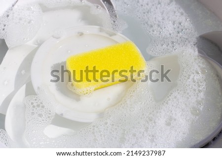 Dish washing, Dirty dishes soaking in kitchen sink. Royalty-Free Stock Photo #2149237987