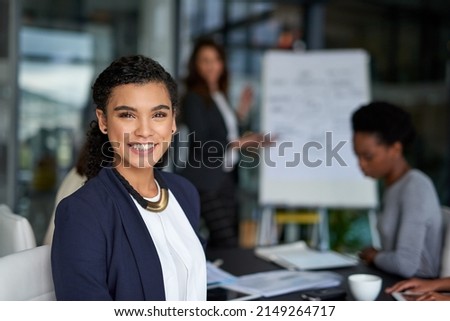 These meetings never disappoint. Portrait of an attractive young businesswoman sitting in the boardroom during a meeting.