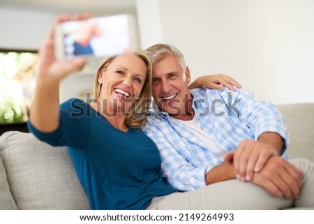 Capturing the beauty of love. Cropped shot of a mature couple taking a selfie together at home.