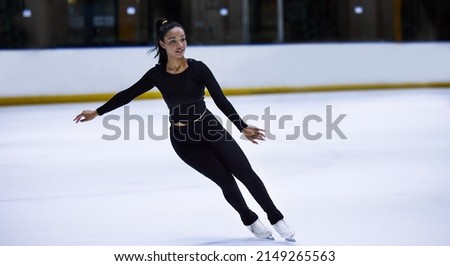 Balance is all a skate of mind. Shot of a young woman figure skating at a sports arena.