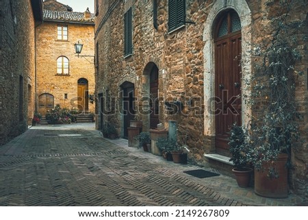 Rustic tuscan stone houses and cozy entrances decorated with colorful plants. Fantastic street view in Tuscany, Italy, Europe  Royalty-Free Stock Photo #2149267809