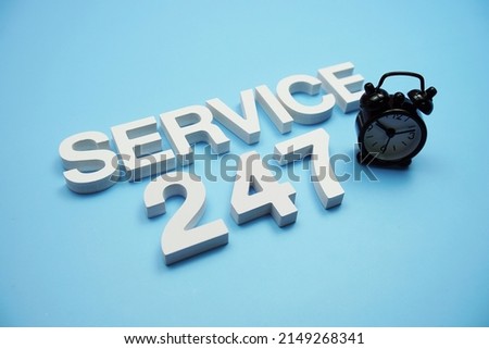 24 Hrs 7 Day Service alphabet letters on blue background