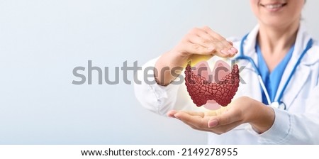 Female endocrinologist with digital projection of thyroid gland on light background, closeup Royalty-Free Stock Photo #2149278955