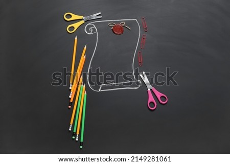 Composition with stationery and drawn vintage scroll on dark background