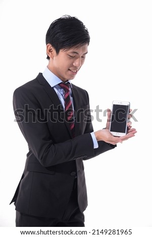 portrait of young businessman in suit ,tie standing with holding cellphone   posing white background