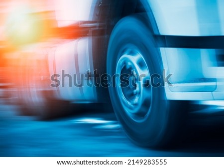 Semi Truck Fast Speed Motion. Spinning Truck Wheels. Trucks Driving on the Road. Diesel Truck. Freight Truck Logistics Shipping Cargo Transport Concept.