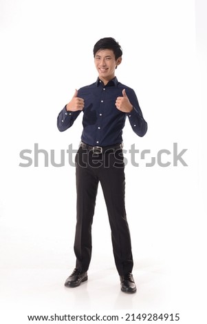 Full body portrait of young man in blue shirt with hands, thumbs up  standing posing white background