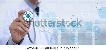 medical technology network concept. Medicine doctor hand with stethoscope touching icon medical network connection with modern virtual screen interface, telemedicine