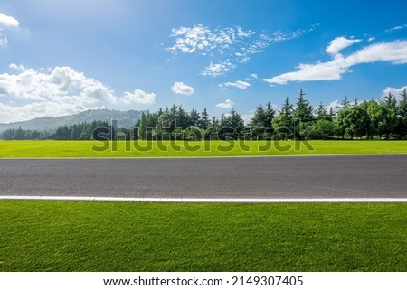 Empty asphalt road and forest with mountain nature landscape under blue sky Royalty-Free Stock Photo #2149307405