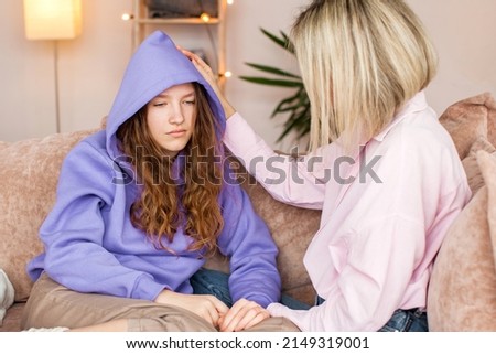 Caring Caucasian mother talk comfort unhappy sad teenage daughter suffering from school bullying or psychological problems, loving mom support make peace with depressed introvert teen girl child Royalty-Free Stock Photo #2149319001
