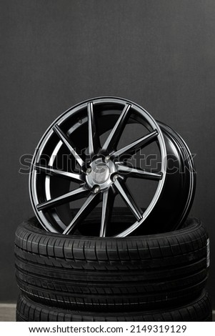 Black stylish forged sports shiny car rim on car tires Royalty-Free Stock Photo #2149319129