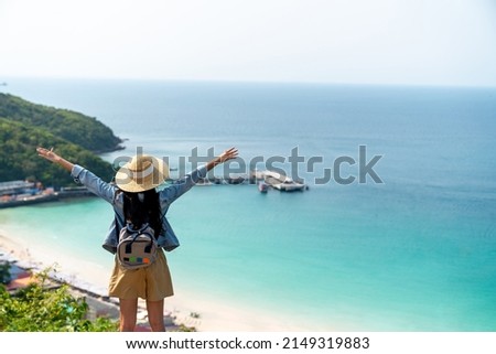 4K Young beautiful Asian woman with backpack solo travel on tropical island mountain peak in summer sunny day. Cheerful female relax and enjoy outdoor lifestyle in summer beach holiday vacation trip Royalty-Free Stock Photo #2149319883