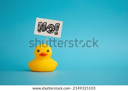 Rubber duck carries a signboard with the word no. Political activism and voting concept.