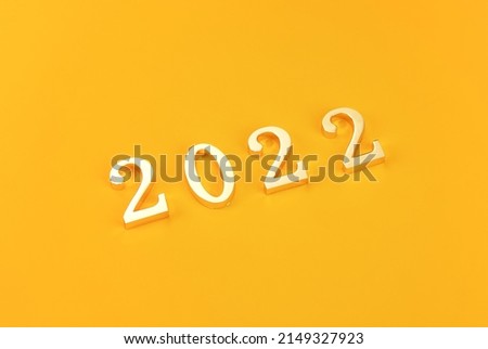 Happy new year 2022 digital material on yellow background