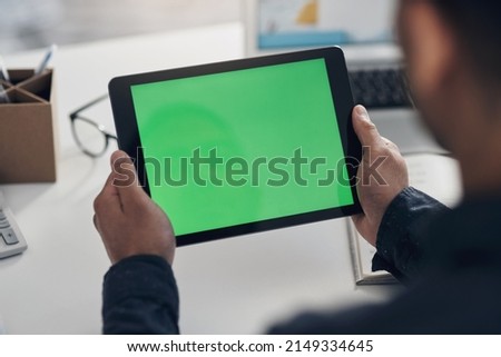 Checking out the website from a users perspective. Cropped shot of an unrecognizable businessman sitting alone in his office and using a digital tablet.