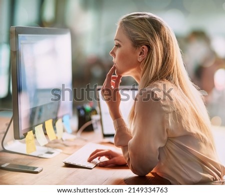 Shes very thorough with her work. Shot of a focused young businesswoman working on a computer in an office.