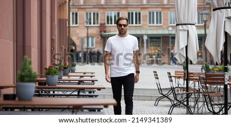 White blank t-shirt on a hipster handsome male model with space for your logo or design in casual urban style
