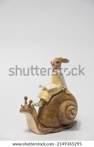 White Easter bunny rabbit with shopping basket and painted eggs on blue and pink background
