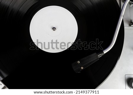 Close up of turntable needle on a vinyl record. Turntable playing vinyl. Needle on rotating black vinyl. Royalty-Free Stock Photo #2149377911