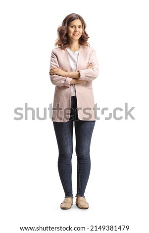 Full length portrait of a young casual woman posing and looking at camera isolated on white background