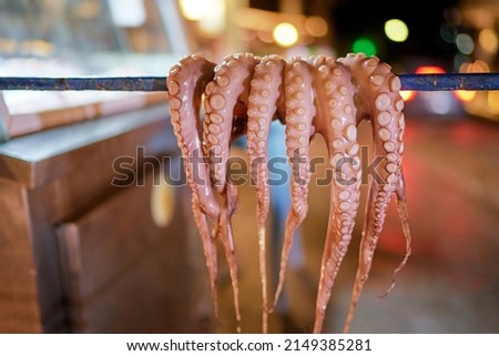 Octopus tentacles dried in a Greek tavern on the street in Greece.