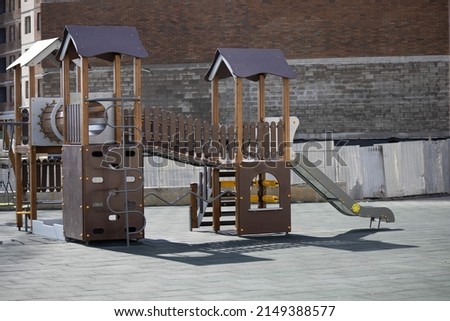 Children's playground on the background of a multi-storey building. High quality photo