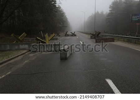 Concrete blocks on the road. War in Ukraine. War activities. Street without cars. Read from the attack. Royalty-Free Stock Photo #2149408707