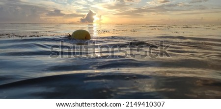 Wonderful view of a warm orange, yellow sunset by the ocean. Float on the water. Landscape of beautiful nature. Calm and relaxation. Photo can be used for cover, wallpaper