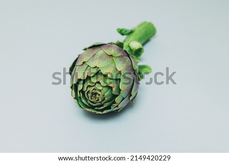 Fresh green Artichokes on a grey background. Flat lay. Place for text.