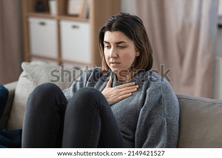mental health, psychological problem and depression concept - sad woman having trouble breathing or panic attack at home Royalty-Free Stock Photo #2149421527