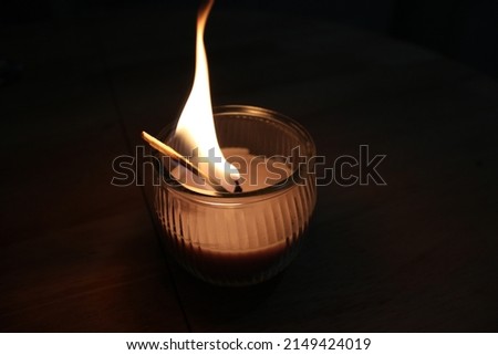 Peaceful picture of a candle and match