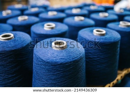 Cotton yarns or threads on spool tube bobbins at cotton yarn factory. Royalty-Free Stock Photo #2149436309