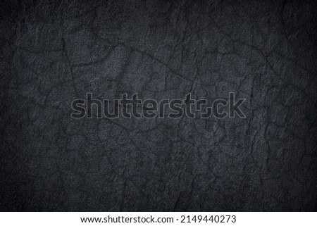 Dark grey black slate stone crack background or texture.